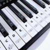 Czarno-białe naklejki z nutami na klawisze keyboardu i pianina
